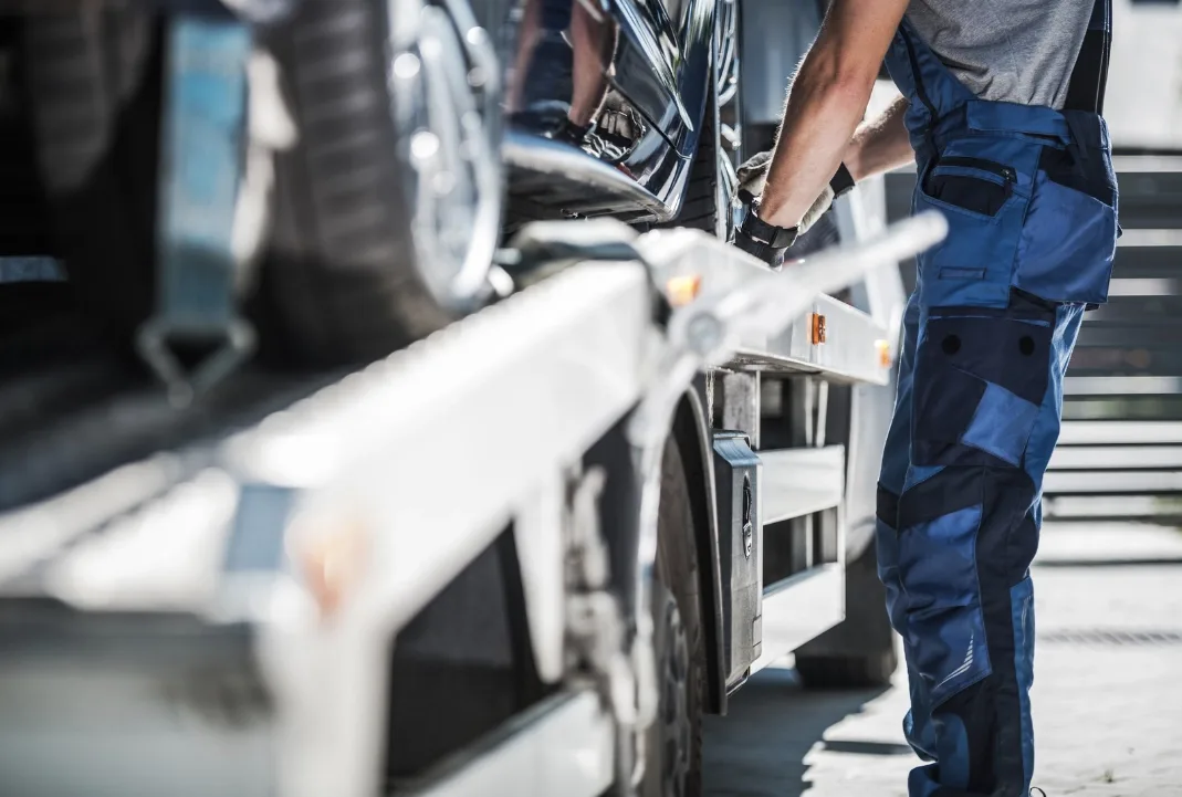 Kitchener tow truck driver loading a car onto a flatbed